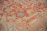 Evenly worn pile of a vintage Persian Heriz carpet showing faded gem-tone colors.