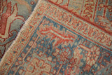 Intact side cord selvage and low pile of a distressed Heriz rug with a Karaja style border.