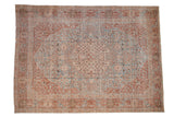 Vintage distressed Tabriz rug with a floral medallion in faded sky blue, plum, and antique ivory.