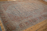 Angled perspective of a distressed vintage Tabriz carpet highlighting its softly faded design.