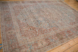 Safavid-inspired border with cloudbands in dusty sky blue on a distressed hand-knotted Tabriz rug.