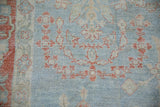 Hand-knotted texture showing even wear on a distressed Mahal rug with terracotta floral sprays.