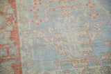 Close-up view of the even wear and serrated floral contours on a distressed Mahal carpet.