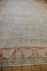 Textural low-angle view of a distressed Mahal rug in powder blue and terracotta.