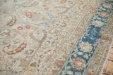 Even wear on a vintage Persian carpet highlights the dusty sapphire blue border and copper floral details.