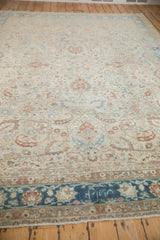 A weaver's signature is detailed in the sapphire blue main border of a vintage distressed Persian rug.