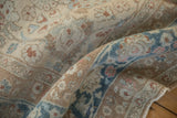 Low, even pile on a distressed Persian rug with copper, sand, and sapphire blue florals.