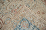 Folded corner of a distressed Meshed carpet showing the hand-knotted foundation and worn pile.