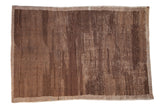 Vintage Turkish Tulu carpet with varied banded thickness in coffee brown and beige.