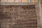 Vintage Tulu carpet pile with varied banded horizontal striations in coffee brown and beige tones.