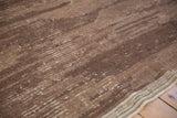 Vintage Tulu carpet detail: coffee brown and beige horizontal striations, banded texture, side selvage.