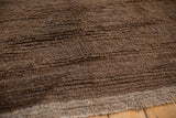 Close-up of Vintage Tulu carpet pile revealing varied brown banded texture and striations.