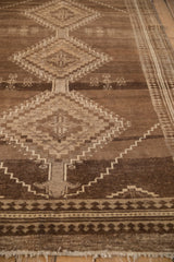 Worn pile of a vintage Kars carpet, with geometric diamond and pawn border patterns.