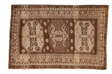 Distressed vintage Kars carpet with three large octagonal medallions in earthy brown and silver tones.