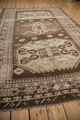 Angled view of a distressed Kars rug's octagonal medallions and pawn design motif borders.