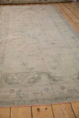 Distressed vintage Oushak runner with faded floral patterns and soft, decorative wear.