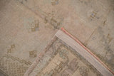 Distressed Oushak rug pile texture and woven back, showing intact reddish selvage.