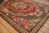 Vintage Khotan carpet's European-influenced floral blossoms and red-brown border.