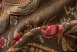 Textured pile detail of vintage Khotan carpet, vibrant fuchsia floral blossoms.