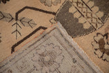 A folded corner of a vintage distressed Khotan carpet reveals its hand-knotted foundation.