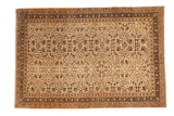 Vintage Kaisary carpet with a quatrefoil floral field in neutral shades of cream, brown, and gold.