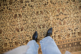 Detail view of a vintage Kaisary carpet's even pile and intricate floral crab motifs in brown and cream.