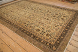 Angled view of a vintage Kaisary carpet, showing its full floral pattern and multi-layered border.