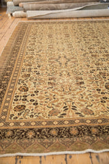 A perspective view of the vintage Kaisary carpet, showing its intricate floral field and dark chocolate brown borders.