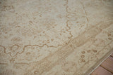 Detail of sprawling pale brown vines and low pile texture on a vintage distressed Kaisary carpet.