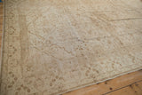 A low-angle view across the vintage Kaisary carpet, highlighting its distressed, low-pile texture.