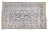Vintage Agra carpet with a blue and ivory tree of life pattern set in repeating cartouches.