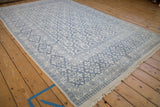Angled view of the vintage Agra carpet's plush texture and slate blue pattern.