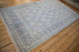 Angled view of the soft plush pile on a vintage Agra carpet with blue and ivory repeating panels.