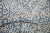 Soft folds reveal the plush, even pile of the vintage Agra carpet.