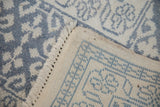 Corner view of a vintage Agra carpet showing the plush blue pile and hand-knotted cotton foundation.