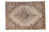 Decorative vintage Oushak carpet with pale field and aubergine geometric diamond medallion.