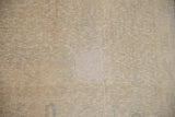 Detail of a rectangular patch on the worn, low-pile vintage Oushak carpet.
