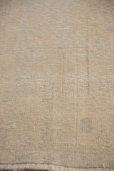 Detail of a distressed Oushak carpet's pile, worn to the hand-knotted foundation.