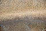 Detailed view of the distressed Oushak rug's hand-knotted pile, showing its texture and character.