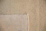The reverse of a vintage Oushak carpet showing its hand-knotted wool foundation.
