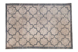 Distressed Indian carpet in a Moroccan design with a charcoal blue lattice pattern on a heavily abraded ivory field.
