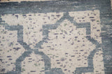 Distressed hand-knotted pile showing knot heads and heavy color abrashes in denim blue and ivory.