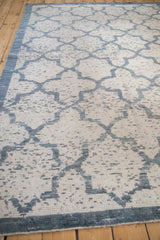Angled view showcasing the varied texture and silk-like pile of the distressed Moroccan design rug.