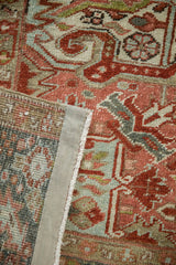 Detail of vintage Heriz rug showing distressed cherry red pile, geometric pattern, and woven foundation.