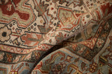 Folded vintage Heriz carpet, textured pile, showing even wear, abrashes, red, ivory, dusty teal.