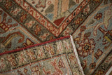 Distressed Heriz carpet, displaying red cord selvage, fringe, and abraded pile with color shifts.