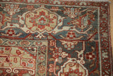 Textured distressed Heriz rug close-up: Samovar Turtle border, pomegranate red, slate blue.