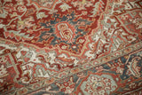 Vintage distressed Heriz carpet with time-softened red, blue, sand, and Samovar Turtle motifs.