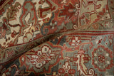 Samovar Turtle motif on the dusty slate blue and cherry red border of a distressed Heriz rug.