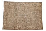 Vintage distressed Mehrivan carpet with a geometric vine pattern in soft, earthy tones of sand, beige, and cream.